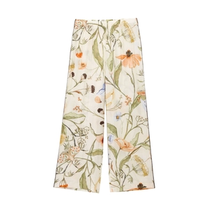 Detailed close-up of lightweight wide-leg trousers featuring vintage floral print patterns