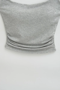 Detailed close-up of light grey knit fabric texture on a slim-fit camisole top