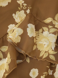Detail of floral chiffon fabric with ruffles and delicate stitching on summer dress