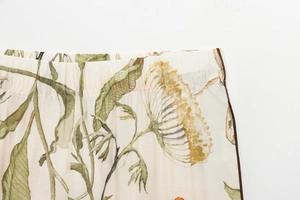 Detail of elastic waistband and floral print on light woven summer two-piece set