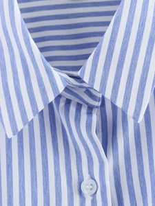 Detailed close-up of blue and white striped shirt collar with a translucent button