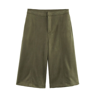 Detail of high-waist olive green suede wide-leg shorts with vertical seam tailoring