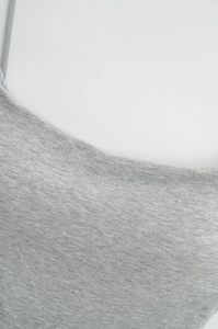 Close-up of gray marl knit fabric texture on a slim fit camisole top for women