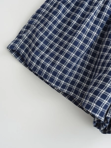 Detail of high-quality navy blue and white plaid fabric with precision stitching
