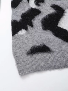 Detailed close-up of grey leopard print knit sweater with soft fuzzy mohair texture