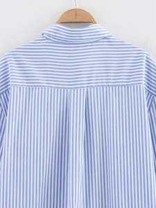 Detail of blue and white striped shirt showing the back yoke and box pleat design