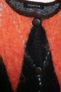 Close-up detail of soft mohair knit texture and dark brown buttons on jacquard cardigan