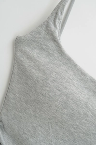 Detail of grey knitted camisole with thin shoulder straps and soft ribbed texture