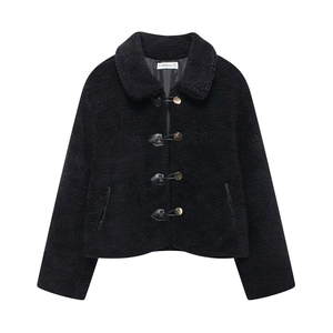 Detailed view of black faux fur jacket with gold buttons and leather trim detailing