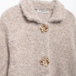 Fuzzy knit cardigan in beige with 3D floral buttons and soft faux fur texture
