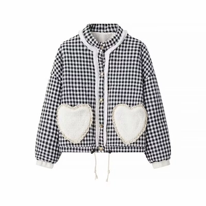 Detail of gingham quilted jacket with heart plush pockets and faux fur trim finish