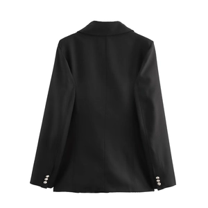 Detail view of the back of a slim fit black blazer with structured seams and buttoned cuffs