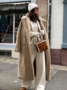 Detail of camel long teddy coat showing thick fleece texture and notch lapel design