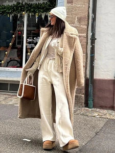 Street style shot of a khaki long teddy coat with matching joggers and winter boots