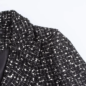 Chic black and white textured tweed blazer with double-breasted buttons for women