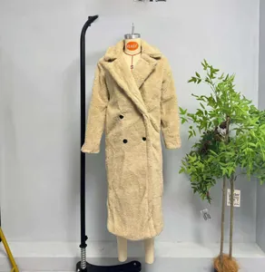 Detail of beige double-breasted teddy fleece coat featuring four large black buttons
