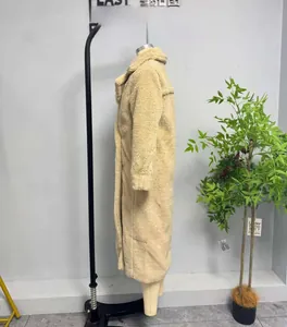 Detailed view of women long beige teddy fleece coat with classic large lapel