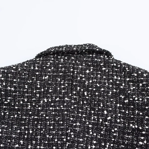 Chic black and white tweed double-breasted jacket with textured fabric and collar detail