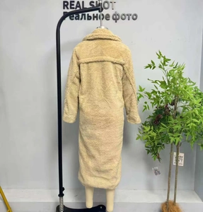 Detailed back view of a camel teddy coat featuring thick fleece fabric and a wide lapel