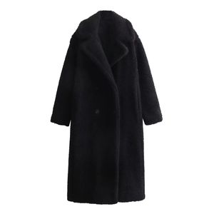 Detail of black double-breasted teddy fleece coat with wide lapels and textured faux fur