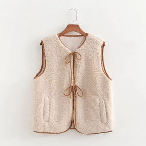 Detail of cream fleece vest with brown lace-up closure and contrasting edge trim