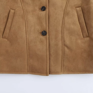 Detail view of brown suede coat featuring round buttons and symmetrical side pockets