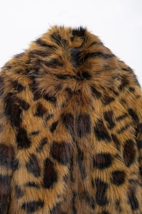 Close-up of fluffy leopard print faux fur coat collar showing thick plush texture