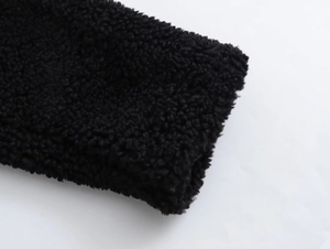 Detailed close-up showing the premium black faux shearling fleece texture and thick fabric