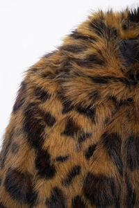 Close-up of leopard print faux fur texture and black fabric lining on winter coat