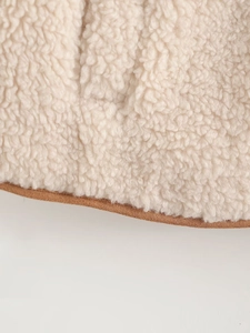 Detail of soft off-white fleece lining and brown suede binding on the garment hem