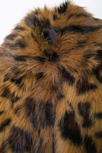 Detailed close-up of soft leopard print faux fur texture on a winter fashion coat