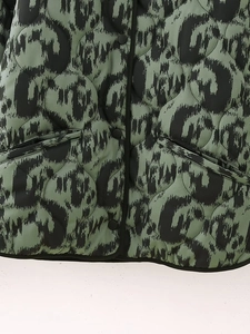 Detail of green quilted jacket featuring black leopard print and snap button closure