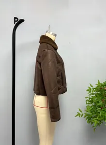 Side view of a brown faux suede jacket with dark shearling collar and lining detail