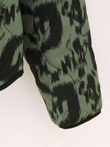 Macro shot of green animal print quilted jacket with diamond stitching and thick fabric texture