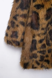 Close-up of fluffy faux fur texture and classic leopard print pattern on coat sleeve
