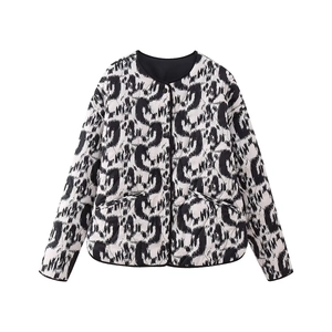 Detail of quilted women's jacket with black and white abstract animal print and buttons
