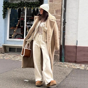 Women's chic beige teddy coat with matching white hoodie set and stylish winter accessories