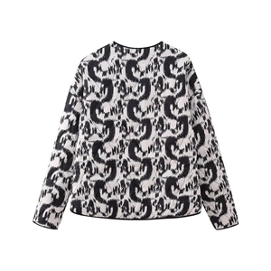 Detail view of the back of a women's quilted jacket with black and white graffiti print