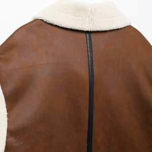 Women's brown shearling-lined faux leather vest with back stripe and fuzzy white collar