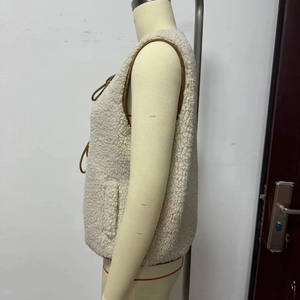 Women's cream fleece vest featuring brown contrast piping and lace-up front closure
