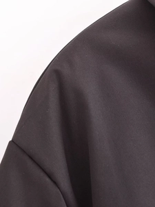 Vue macro détaillée montrant la texture du tissu tissé noir de haute qualité de la veste