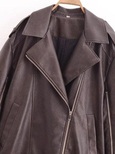 Detail of dark brown faux leather biker jacket featuring metallic zippers and lapels