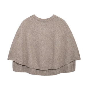 Close-up of ribbed texture and layered design on the beige knit poncho outerwear