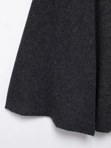 Detail shot of the charcoal grey wool blend knit fabric texture on this poncho coat