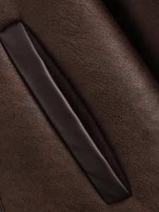 Detail of dark brown faux suede fabric with smooth leather welt pocket stitching