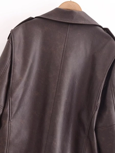Close-up of the back shoulder detail and lapel on a vintage brown leather biker jacket