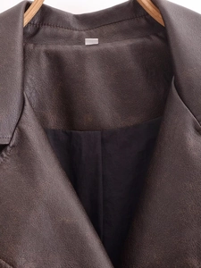 Detailed close-up of deep brown washed leather collar with high-quality grain texture