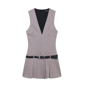 Détail d'une robe plissée sans manches à col en V à carreaux noir et blanc avec ceinture