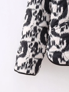 Detail of diamond quilting and black white abstract geometric print on cotton jacket