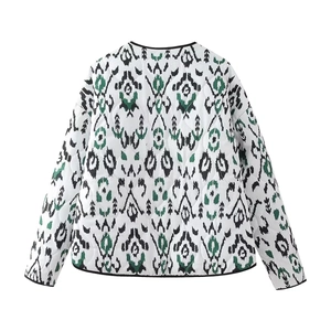 Rear view of women's lightweight quilted jacket with black and green ethnic print